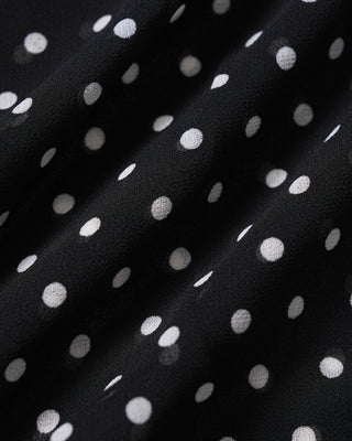 Top sin mangas de cuello barco con lunares negros